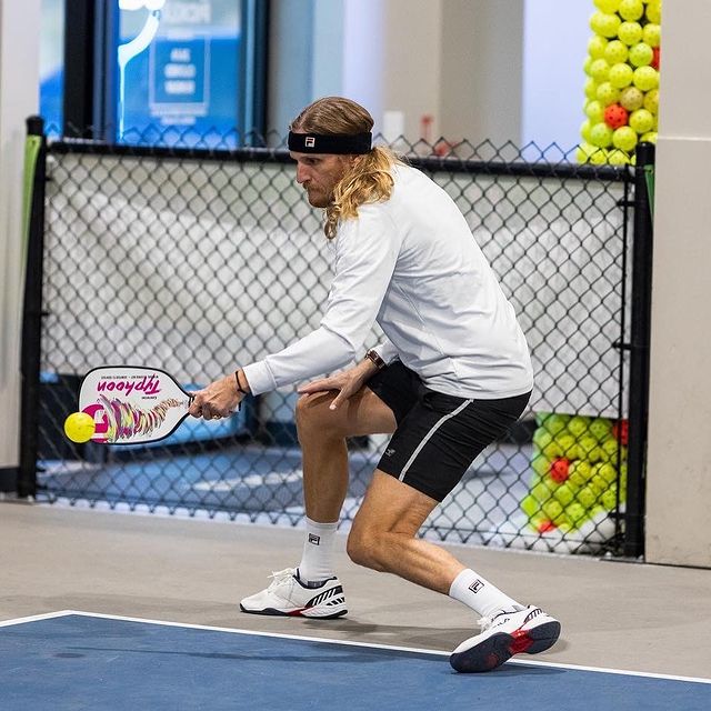 Picture of Tyson Apostol posing for a photoshoot wearing white color t shirt and black color shorts